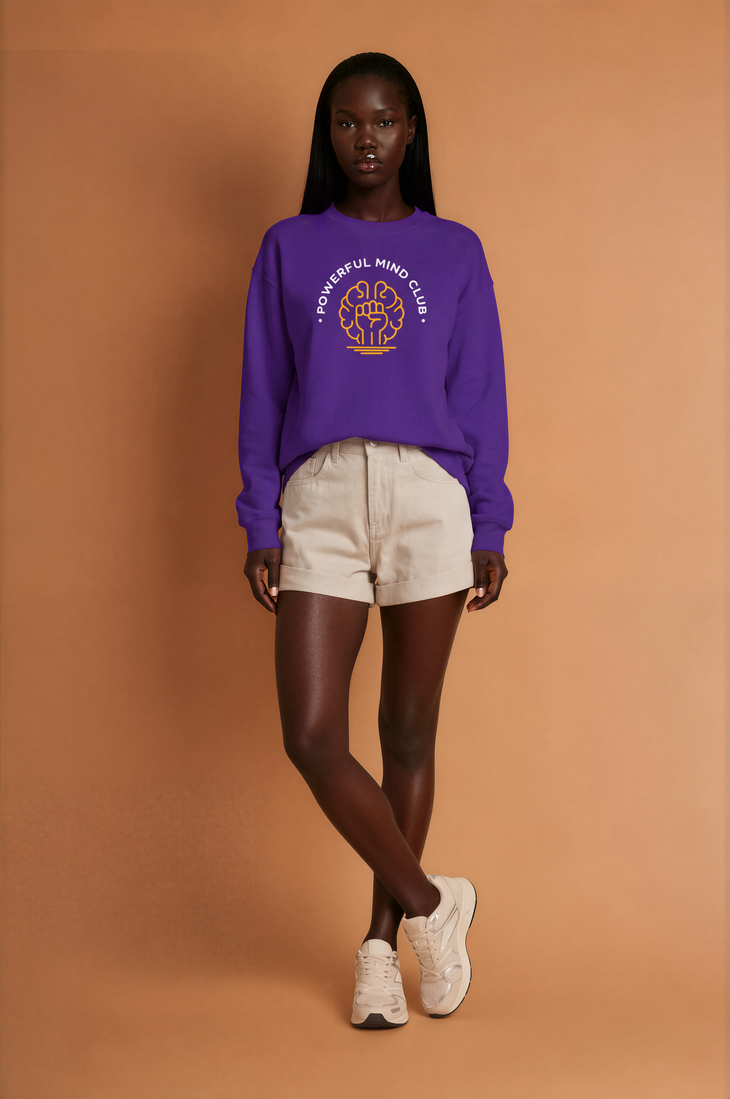 Woman wearing a purple Powerful Mind Club crewneck sweatshirt, full body view