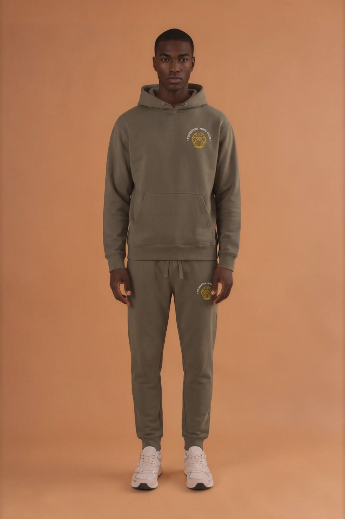 Man wearing a military green Powerful Mind Club Signature Set hoodie and joggers, front view video
